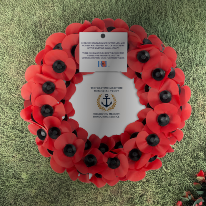 Wreath placed on the deck of a historic vessel.